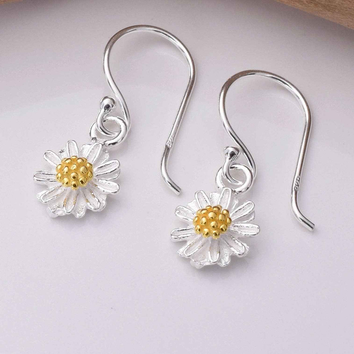 Silver daisy hook earrings with gold-coloured centres